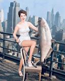 Miss National Catfish Queen. 

Winner and recognized catfish queen Gail Hooper from Tennessee holds a 25 kg catfish at the New Yorker Hotel, 1945.

Photographer: Al Pucci