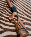 Blaser R8 Success Vintage Review: Design, Calibers,  Configurations, Price, Pros and Cons.

The Blaser R8 Success Vintage is not just a rifle—it’s a statement. Designed for elite hunters and precision shooters, this luxury variant of the iconic Blaser R8 series combines timeless aesthetics, modular engineering, and field-proven performance. Whether you’re stalking red deer in the Alps or preparing for a driven boar hunt in Germany, the R8 Vintage delivers unmatched reliability and elegance.

🧰 Overview and Design Philosophy Blaser R8 Vintage

The R8 Success Vintage is part of Blaser’s Success family, known for its straight-pull bolt action, modular barrel system, and ergonomic thumbhole stock. What sets the Vintage apart is its Grade 6 walnut stock, saddle leather inlays, and gold titanium-nitride accents—a tribute to traditional European gunmaking.

Key Features:

• Action Type: Straight-pull bolt with radial collet locking
• Stock: Grade 6 walnut with matte finish and saddle leather inserts
• Trigger: Direct trigger with gold titanium-nitride finish
• Receiver: Black brushed aluminum with engraved “R8 Vintage” lettering
• Safety: Manual cocking system (de-cocker)
• Modularity: Quick-change barrels, bolt heads, and magazine inserts

🔫 Modifications and Configurations Blaser R8 Vintage

The R8 Vintage is highly customizable via Blaser’s online configurator. Options include:

• Barrel Profiles: Standard, fluted, match-grade
• Lengths: 47 cm, 52 cm, 58 cm, 65 cm
• Silence Version: Integrally suppressed barrel (availability depends on local laws)
• Left-Handed Models: Available
• Engraving & Custom Leather: Optional for collectors

📐 Calibers and Specifications Blaser R8 Vintage

The R8 Vintage supports a wide range of calibers across multiple groups:

Mini Group:

• .204 Ruger, .222 Rem, .223 Rem

Standard Group:

• .243 Win, 6.5 Creedmoor, .270 Win, .308 Win, .30-06 Springfield, 8x57 IS

Magnum Group:

• 7mm Rem Mag, .300 Win Mag, .338 Win Mag, .375 H&H, .416 Rem Mag

Special Group:

• .500 Jeffery, 10.3x60R (single-shot)

Example Configuration (.308 Win):

• Barrel: 52 cm fluted
• Weight: ~3.3 kg
• Magazine: 4+1 detachable box
• Trigger Pull: ~750 g
• Overall Length: ~102 cm

🎯 Effective Range and Hunting Applications

The R8 Vintage is suitable for a wide spectrum of game:

Small Game & Varmints:

• Calibers: .223 Rem, .243 Win
• Range: 200–400 meters

Medium Game (Deer, Boar):

• Calibers: .308 Win, 6.5 Creedmoor
• Range: 300–600 meters

Large Game (Elk, Moose, Bear):

• Calibers: .300 Win Mag, .375 H&H
• Range: 400–800 meters

Dangerous Game (Africa):

• Calibers: .416 Rem Mag, .500 Jeffery
• Range: 100–300 meters

💬 User Reviews: Pros and Cons

✅ Pros

• Exceptional Craftsmanship: Premium wood, leather, and metal finishes
• Modular System: Swap calibers and barrels in minutes
• Straight-Pull Action: Fast cycling, ideal for driven hunts
• Scope Mount Repeatability: Returns to zero after disassembly
• Compact for Travel: Breaks down into a discreet case

❌ Cons

• High Price: MSRP ranges from €8,900 to €10,500 depending on configuration A B C
• No Iron Sights by Default: Requires optics
• Limited Availability: Custom orders may take weeks
• Weight: Heavier than synthetic-stocked models

💵 Pricing and Availability Blaser R8 Vintage

Europe:

• Standard Vintage: €8,900–€9,700
• Silence Version: €10,000+
• Custom Engraved: €11,000+

North America:

• MSRP: $9,500–$11,500 USD
• Available through authorized Blaser dealers

Used Market:

• Rarely available; retains value well

🧠 Why Hunters and Shooters Choose the R8 Vintage

• Elegance Meets Functionality: A rifle that performs and impresses
• Versatility: One rifle, many calibers, multiple hunting styles
• Safety First: Manual cocking system prevents accidental discharge
• Travel-Friendly: Ideal for international hunts
• Legacy Value: Often passed down as heirloom

❓ Frequently Asked Questions (FAQ)

Q: Is the R8 Vintage suitable for dangerous game?
A: Yes, with calibers like .375 H&H and .500 Jeffery, it’s ideal for African safaris.

Q: Can I mount a scope on the R8 Vintage?
A: Absolutely. It uses Blaser’s proprietary saddle mount system with repeatable zero.

Q: Is the Silence version legal in my country?
A: Depends on local laws regarding suppressors. Check with your dealer.

Q: How accurate is the R8 Vintage?
A: Sub-MOA performance is common with factory barrels and quality ammo.

Q: Can I change calibers myself?
A: Yes. Barrel, bolt head, and magazine insert can be swapped in minutes.

⚙️ Mounting Systems and Accessories

Blaser Saddle Mounts

• Exclusive Blaser quick-detach mounts maintain zero after removal
• Available in 30mm and 1-inch ring configurations

Recommended Accessories Blaser R8 Vintage

• Spare Magazines and Bolt Heads: For multi-caliber setups
• Leather Rifle Sling: Matches saddle leather inlays for aesthetic continuity
• Protective Rifle Cases: Blaser aluminum case or Pelican with custom foam
• Cleaning Kits: Ballistol, Hoppe’s Elite, or Blaser-specific sets
• Recoil Pads and Cheek Risers: For customized fit and reduced felt recoil

Suppressed Barrel Compatibility

• R8 Vintage is compatible with integrally suppressed “Silence” barrels, pending regulations
• Requires thread adapter or barrel swap for external suppressors

📌 Final Thoughts

The Blaser R8 Success Vintage is a rifle for those who demand precision, luxury, and adaptability. It’s not just a tool—it’s a companion for life’s greatest hunts. From alpine chamois to African buffalo, the R8 Vintage is engineered to perform and crafted to impress.

If you’re ready to invest in a rifle that blends German engineering with timeless style, the R8 Vintage is your answer.